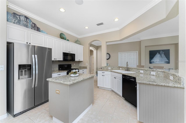 105 Treviso Ct, North Venice, FL 34275 - kitchen with black appliances, a sink, arched walkways, white cabinets, and a peninsula