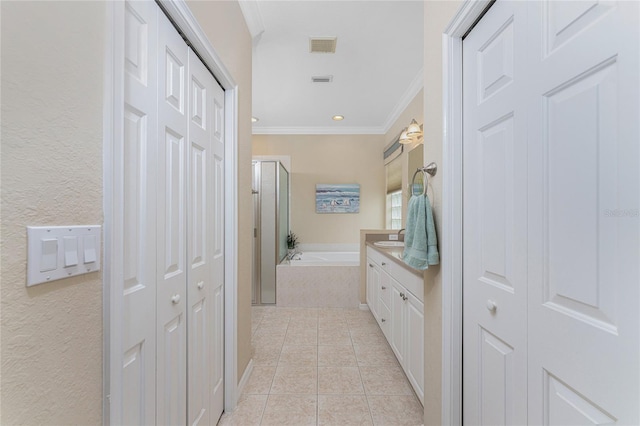 hall with sink, light tile patterned flooring, and ornamental molding