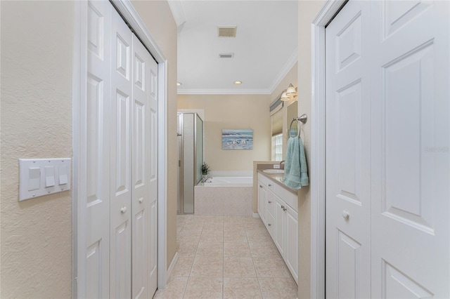 105 Treviso Ct, North Venice, FL 34275 - bathroom featuring a closet, a bath, ornamental molding, tile patterned flooring, and vanity