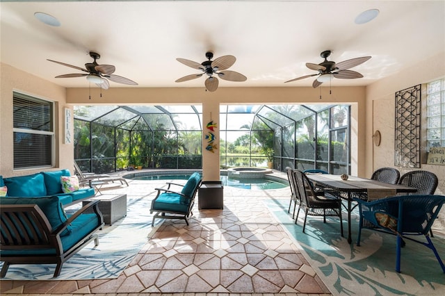 view of patio / terrace featuring glass enclosure, ceiling fan, and an outdoor hangout area