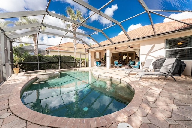 view of pool with a lanai, a patio area, ceiling fan, and an in ground hot tub