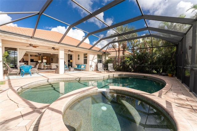 view of swimming pool with an in ground hot tub, an outdoor hangout area, ceiling fan, glass enclosure, and a patio