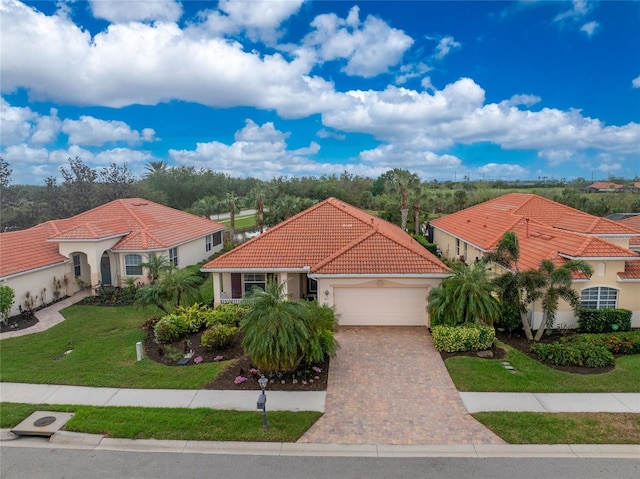 mediterranean / spanish-style home featuring a front yard and a garage