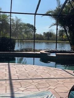 105 Treviso Ct, North Venice, FL 34275 - swimming pool with glass enclosure, a water view, and a patio