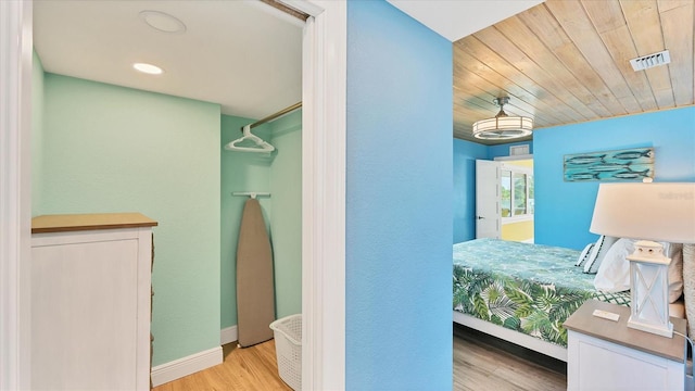 bedroom with light hardwood / wood-style floors and wood ceiling