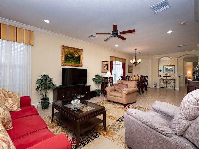 living room featuring ceiling fan with notable chandelier, light tile patterned floors, and crown molding