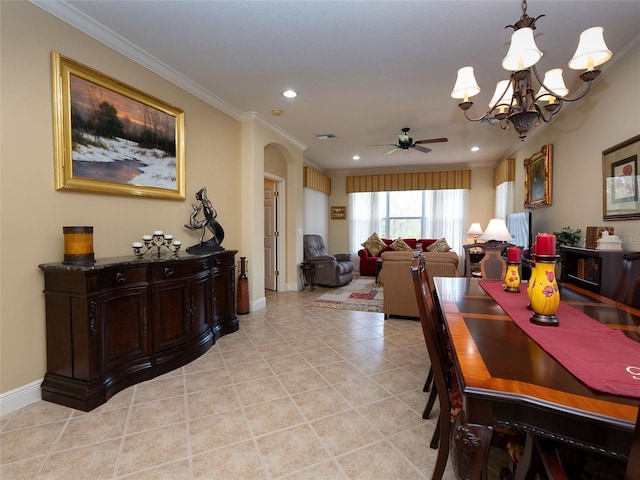 tiled dining room featuring ceiling fan with notable chandelier and crown molding