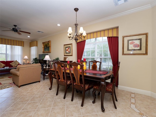 dining area with a wealth of natural light, ornamental molding, and ceiling fan with notable chandelier