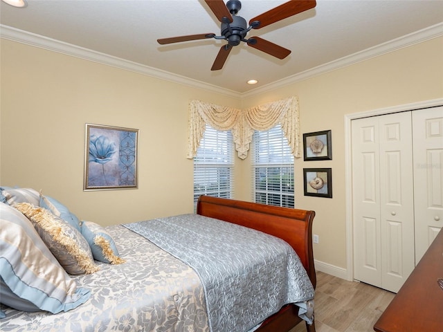 bedroom with light hardwood / wood-style floors, ceiling fan, a closet, and ornamental molding