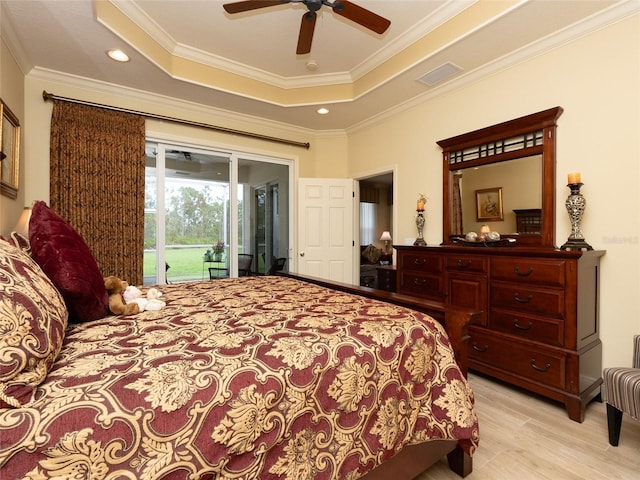 bedroom featuring access to outside, light hardwood / wood-style floors, ornamental molding, ceiling fan, and a raised ceiling