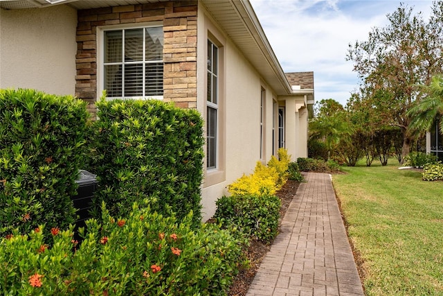 view of property exterior with a yard