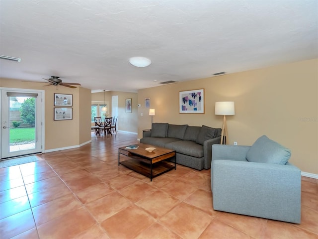 tiled living room featuring ceiling fan