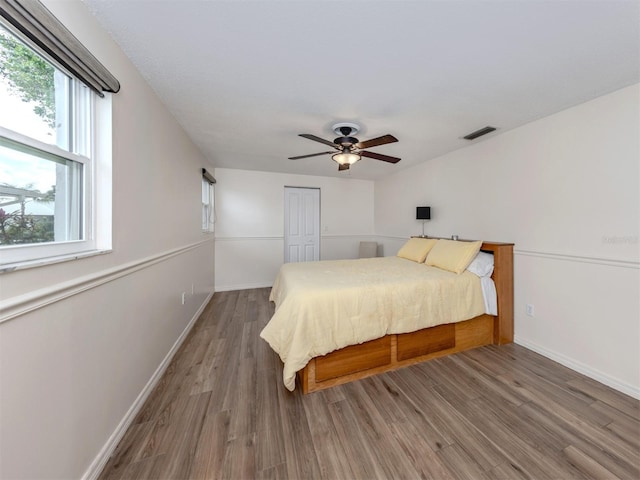 bedroom featuring a closet, hardwood / wood-style flooring, and ceiling fan