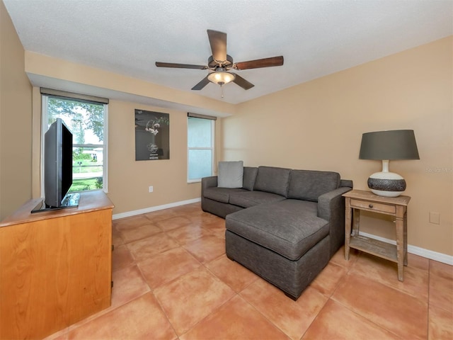 tiled living room with a textured ceiling and ceiling fan