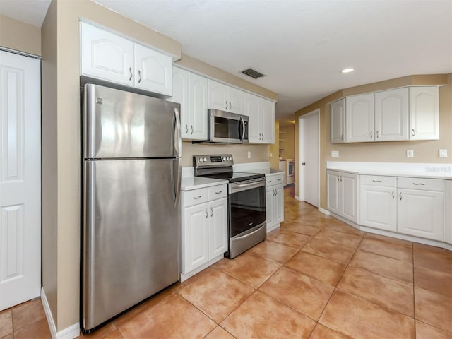 kitchen featuring white cabinetry, appliances with stainless steel finishes, and light tile patterned floors