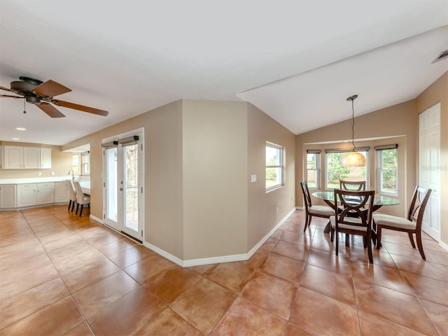 dining room featuring lofted ceiling, light tile patterned floors, and ceiling fan