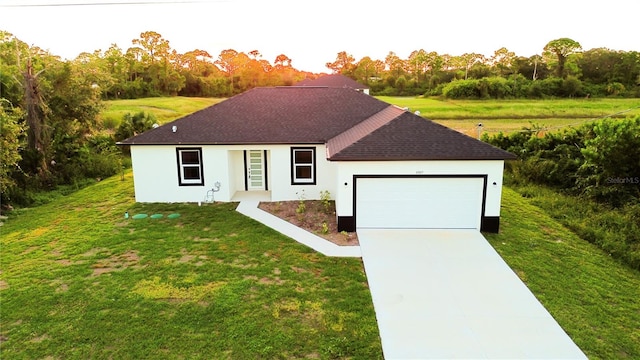 single story home featuring a garage and a front lawn