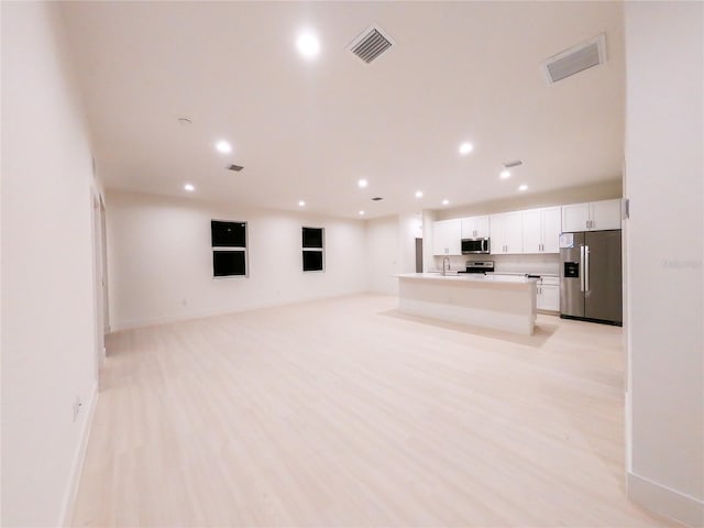 unfurnished living room with light hardwood / wood-style floors