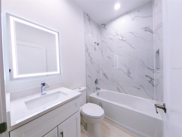 full bathroom with toilet, tiled shower / bath combo, and vanity