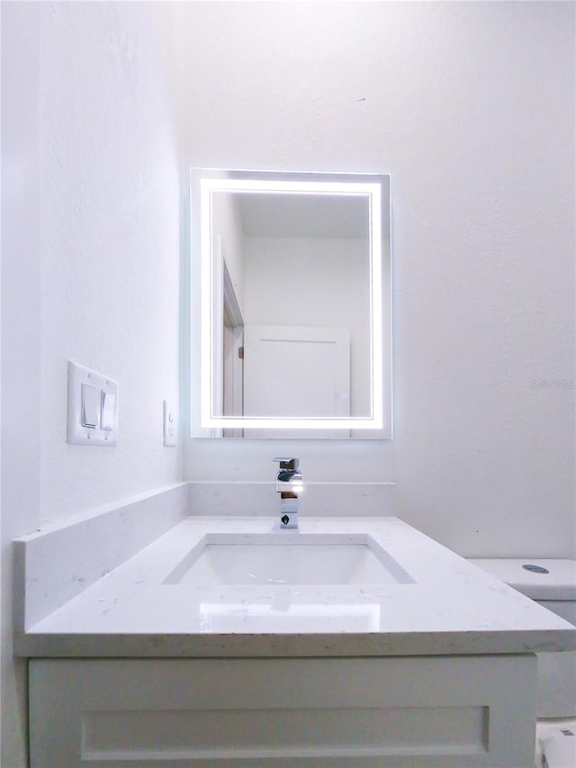 bathroom featuring toilet and vanity