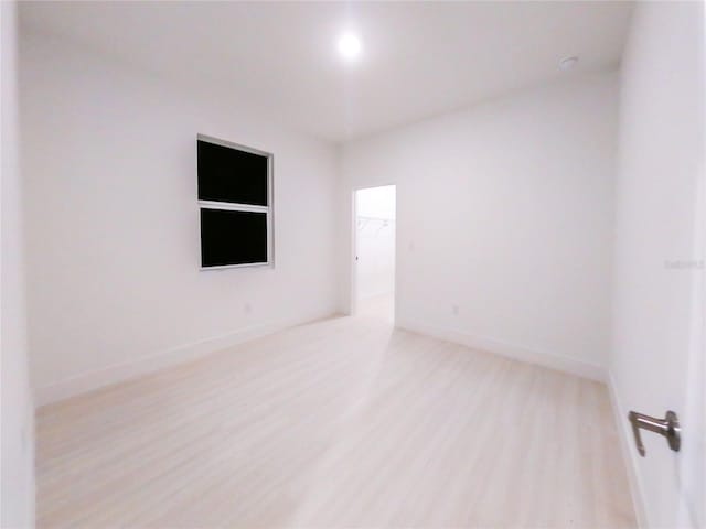 spare room with light hardwood / wood-style flooring