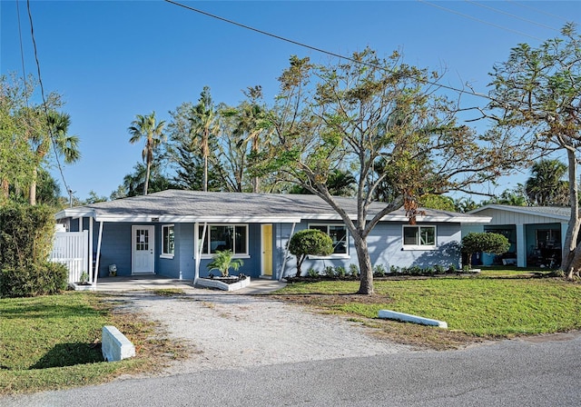 ranch-style home with covered porch and a front yard