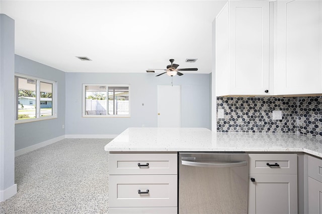 kitchen with decorative backsplash, stainless steel dishwasher, ceiling fan, light stone countertops, and white cabinetry