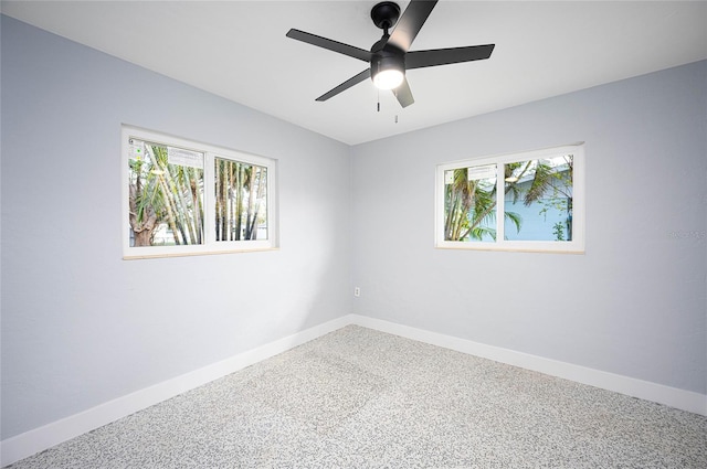 unfurnished room featuring ceiling fan and carpet flooring