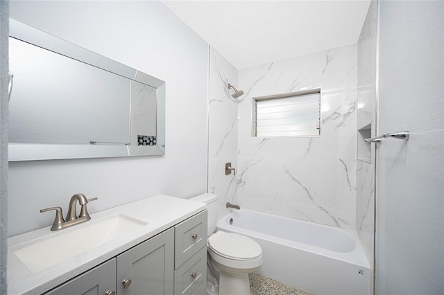 full bathroom featuring tiled shower / bath, vanity, and toilet