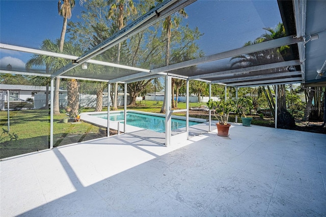 view of swimming pool with a lanai, a yard, and a patio area