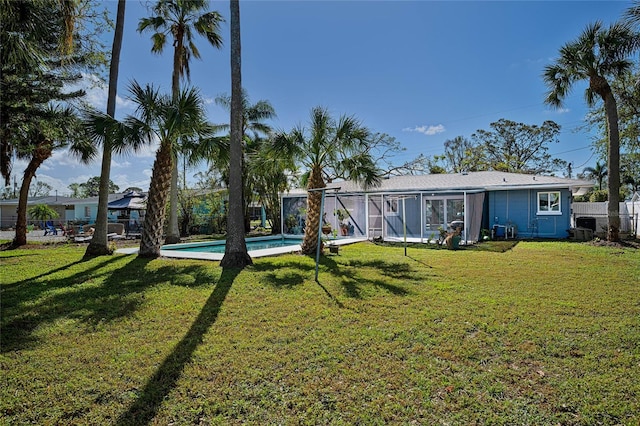 rear view of property featuring a yard