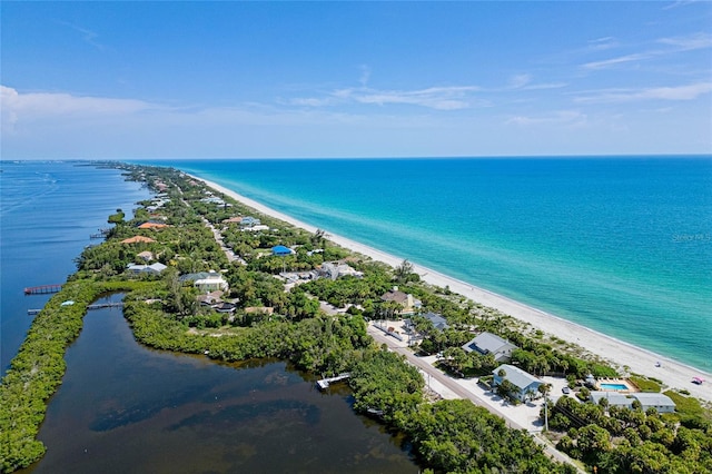 drone / aerial view featuring a beach view and a water view