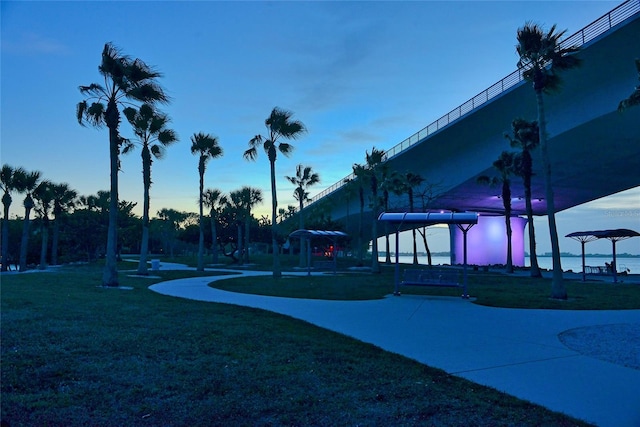 view of community with a water view and a lawn