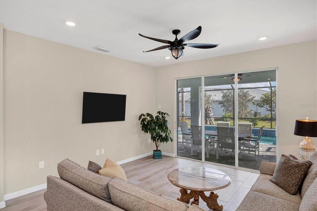 living room with ceiling fan and light hardwood / wood-style floors