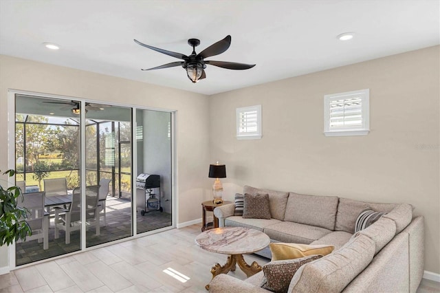 living room featuring ceiling fan and light hardwood / wood-style flooring