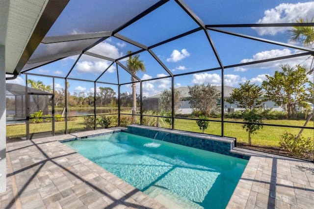 view of swimming pool featuring a lanai, a patio area, pool water feature, and a lawn