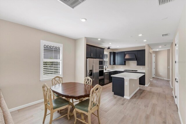 dining room with light hardwood / wood-style floors and sink