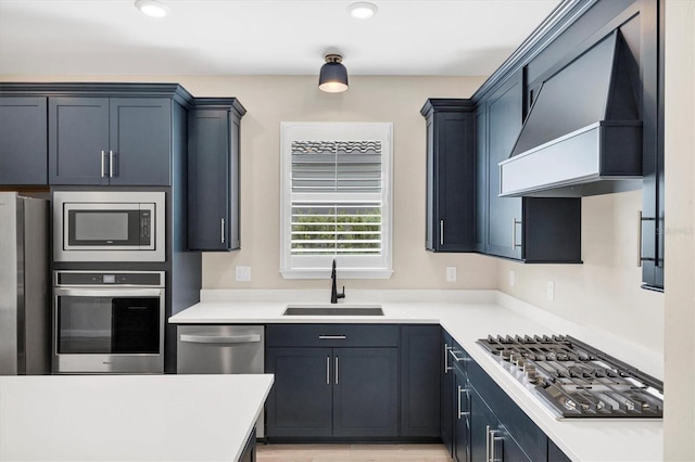 kitchen featuring sink, custom range hood, and appliances with stainless steel finishes