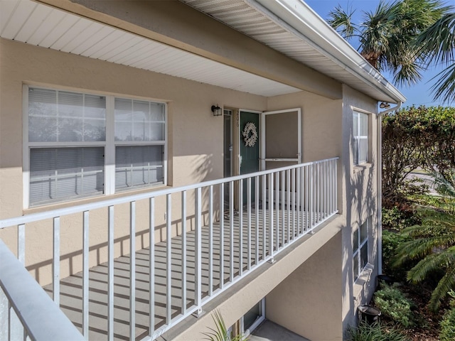 view of exterior entry featuring a balcony