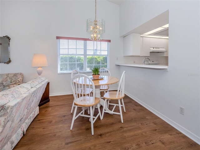 dining room with dark hardwood / wood-style flooring and a notable chandelier