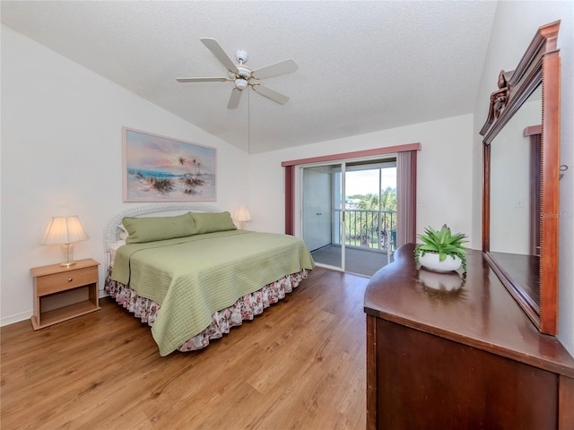 bedroom featuring vaulted ceiling, ceiling fan, access to exterior, a textured ceiling, and light hardwood / wood-style floors