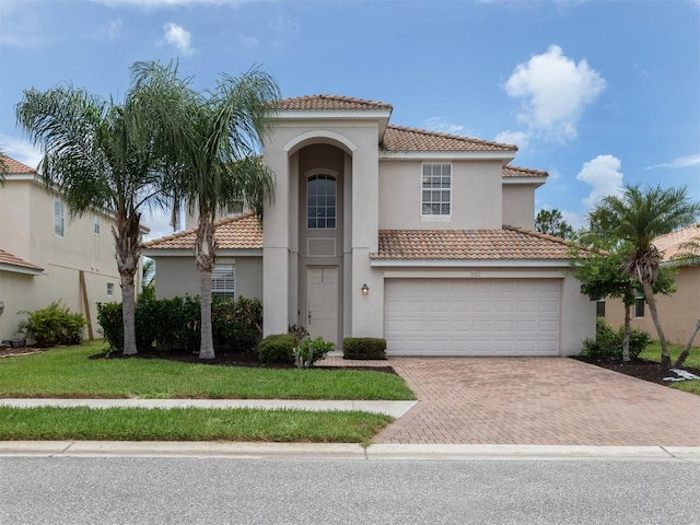 mediterranean / spanish-style house with a garage and a front yard