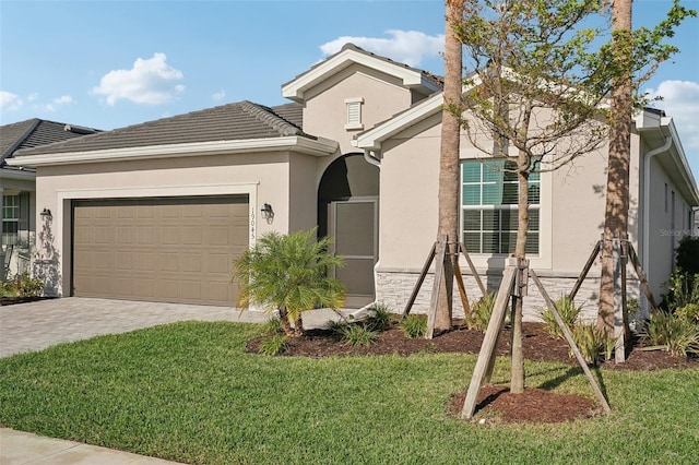 view of front of house featuring a garage and a front lawn