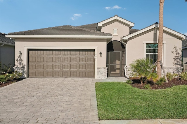 single story home featuring a garage and a front yard