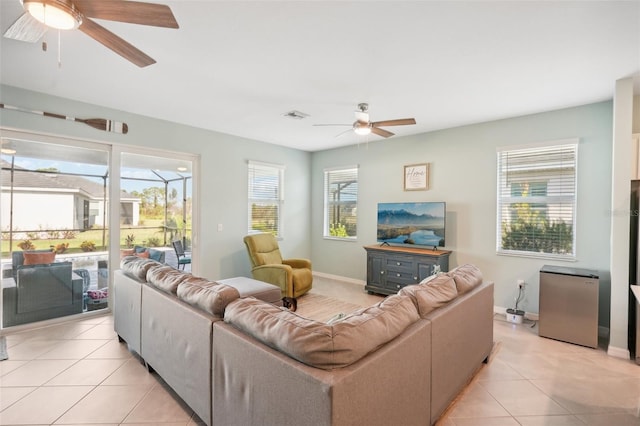 tiled living room featuring ceiling fan