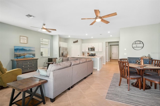 living room with light tile patterned floors and ceiling fan