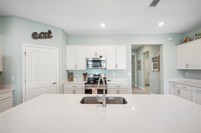 kitchen featuring white cabinetry, appliances with stainless steel finishes, and sink