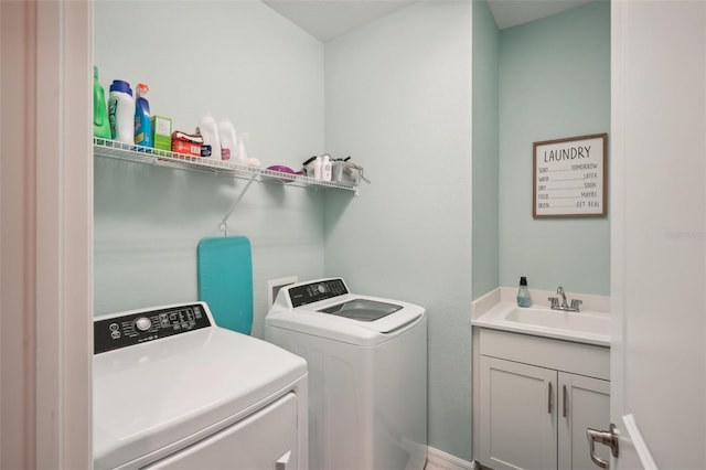 laundry area featuring cabinets, sink, and washer and clothes dryer