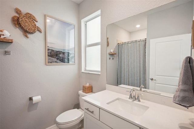 bathroom with vanity, toilet, and a shower with curtain