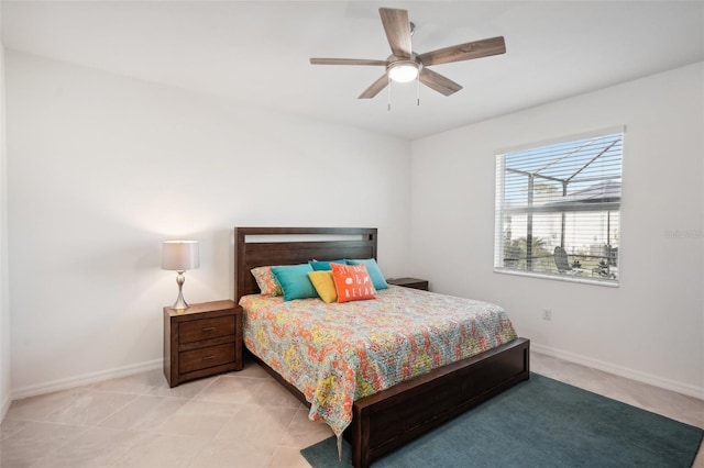 bedroom with ceiling fan and light tile patterned floors